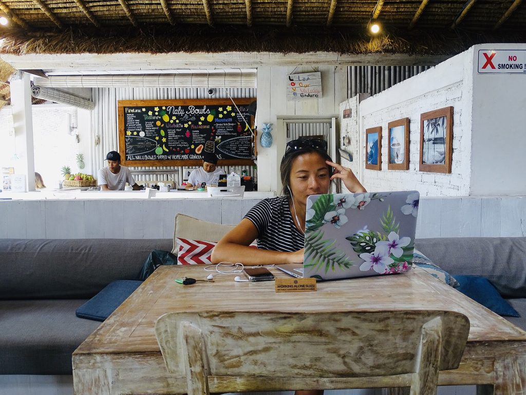 Remote Work Evidence: What the Data Says — and Why Visa Policy Is Listening A remote worker with a laptop at a bright desk while travelling