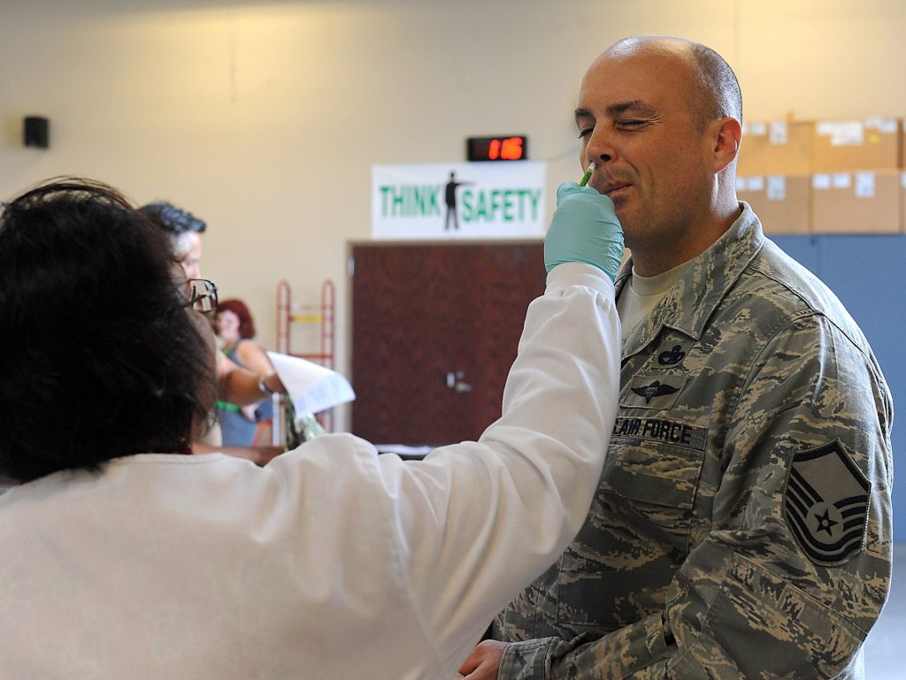 Travellers’ Guide as US Measles Cases Rise to 4,410 Healthcare worker preparing a measles vaccination for a patient